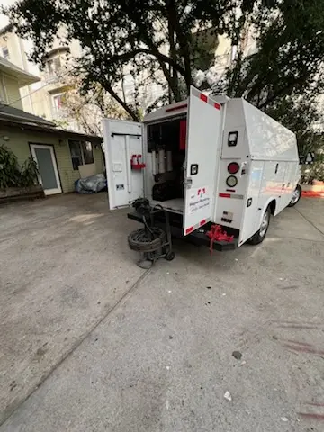 Magnet Plumbing service vehicle on-site for Grease Trap Cleaning in Brickell Residential District